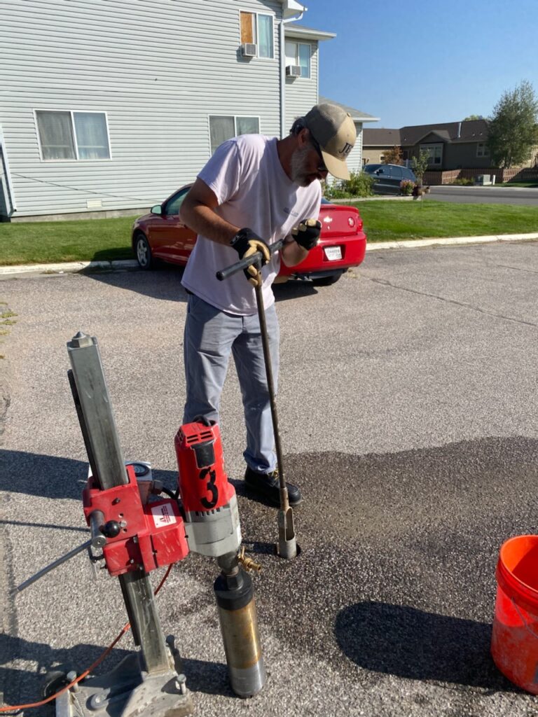 JB Engineers employee using special equipment to test asphalt