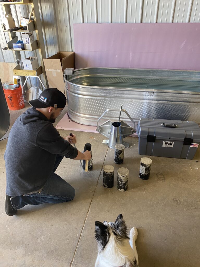 JB Engineers employee working with soil samples as a dog watches