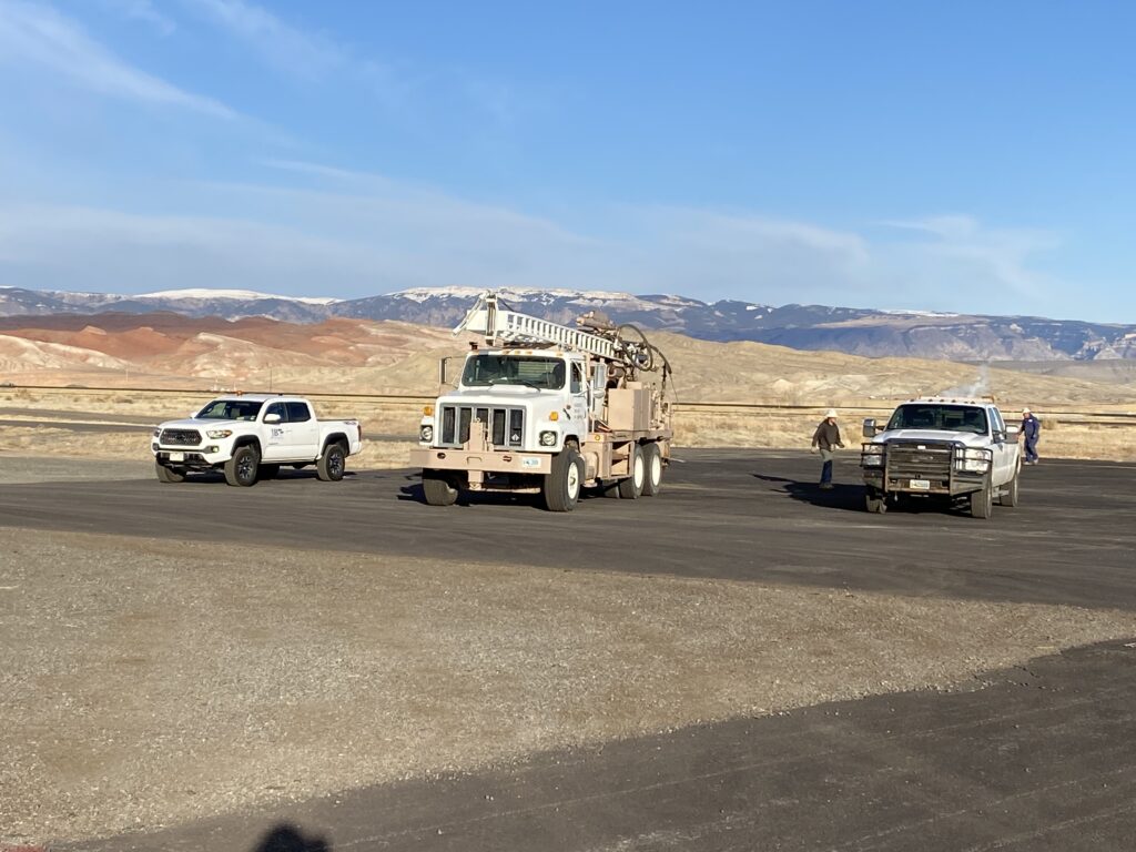 White work trucks on a job site in the Rocky Mountains - JB Engineers