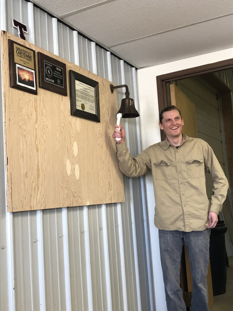 JB engineers employee ringing the work bell